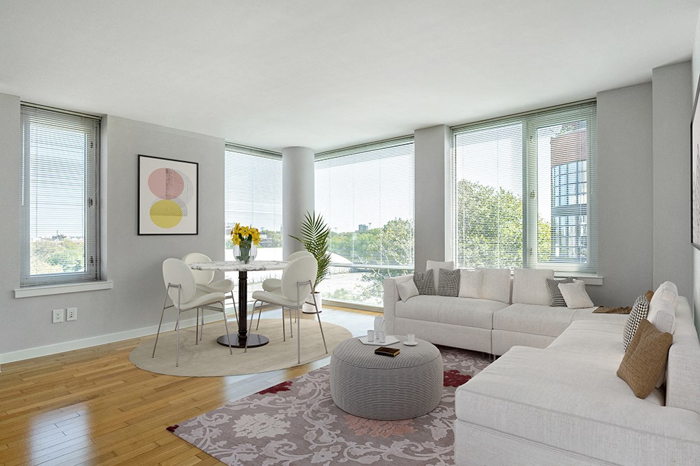 a living room with a white couch and a table with chairs at 34 Berry, Brooklyn, NY, 11249